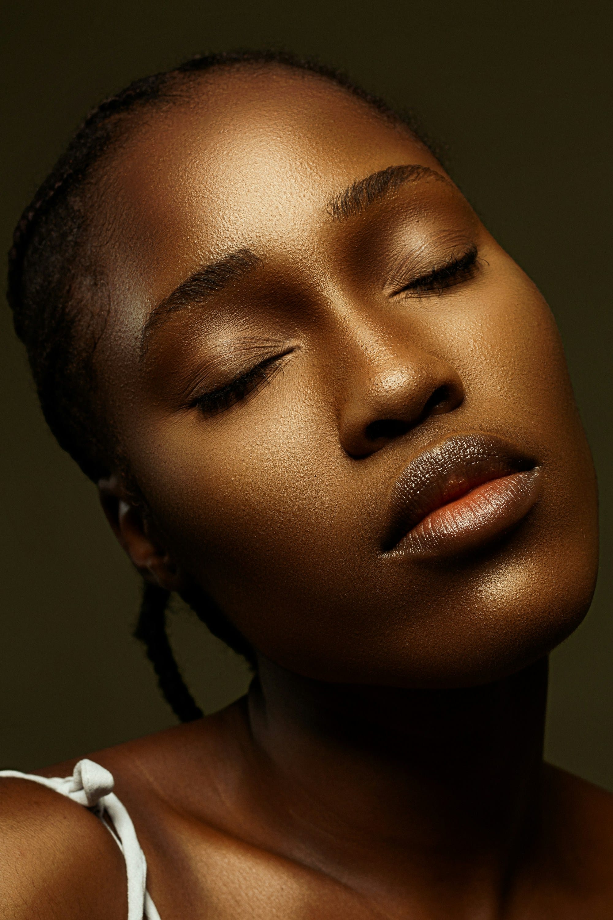 Model with closed eyes and luminous skin — the DermaSelene standard
